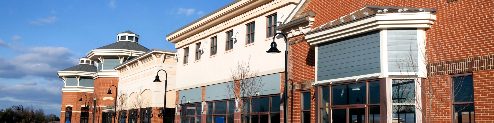 A row of brick buildings with a blue sky in the background.
