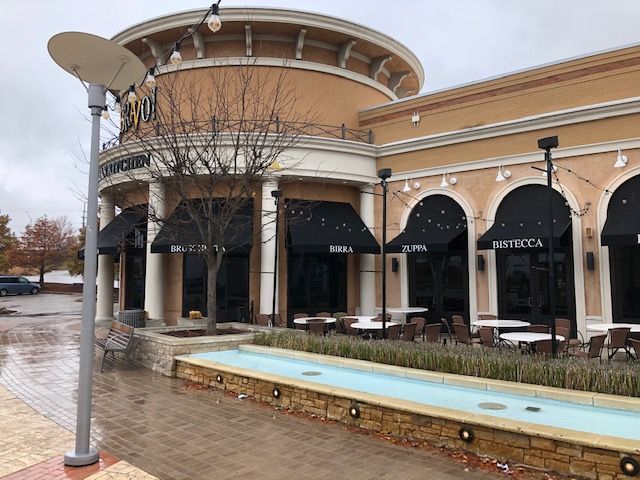 A large building with a fountain in front of it