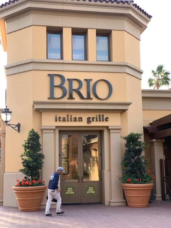 A man walks in front of a brio italian grille