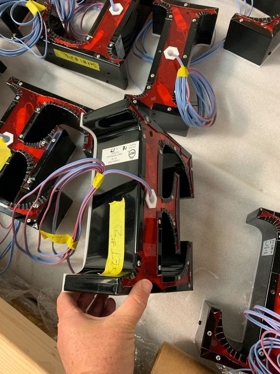 A person is holding a piece of electronic equipment in their hand.