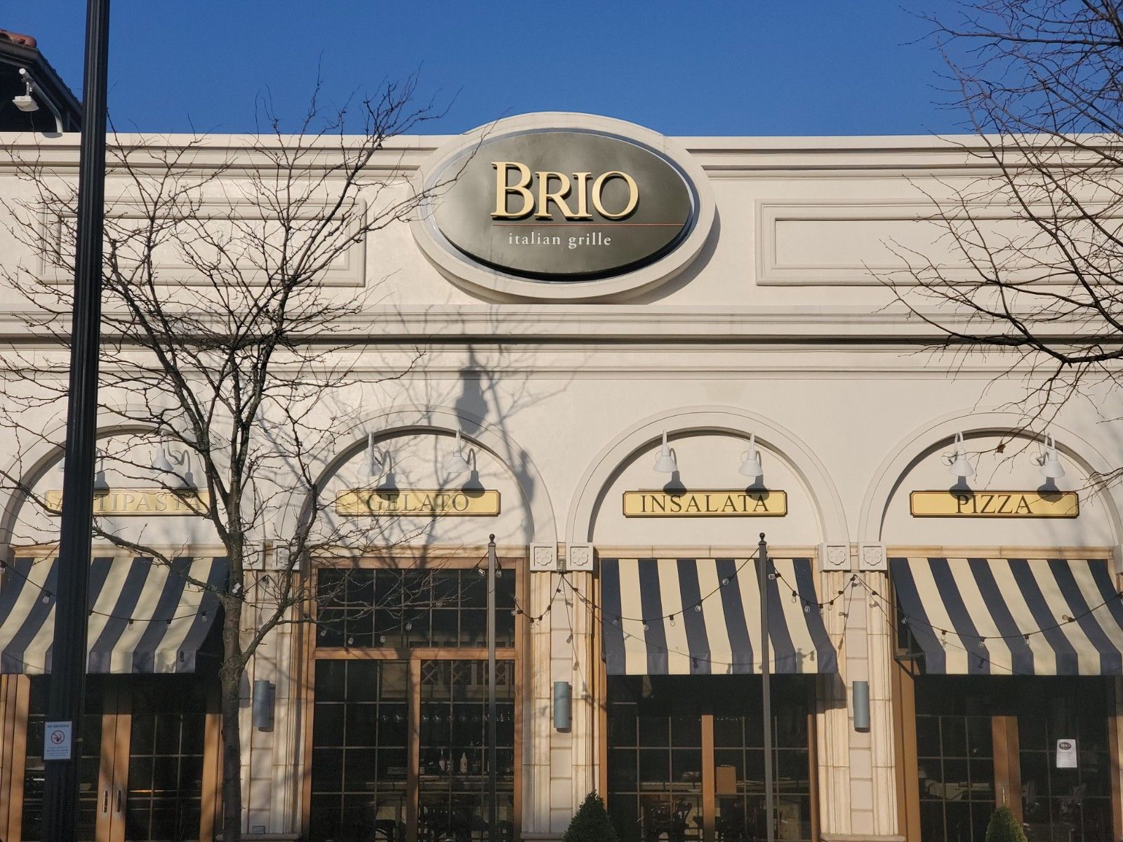 A white building with a sign that says brio on it