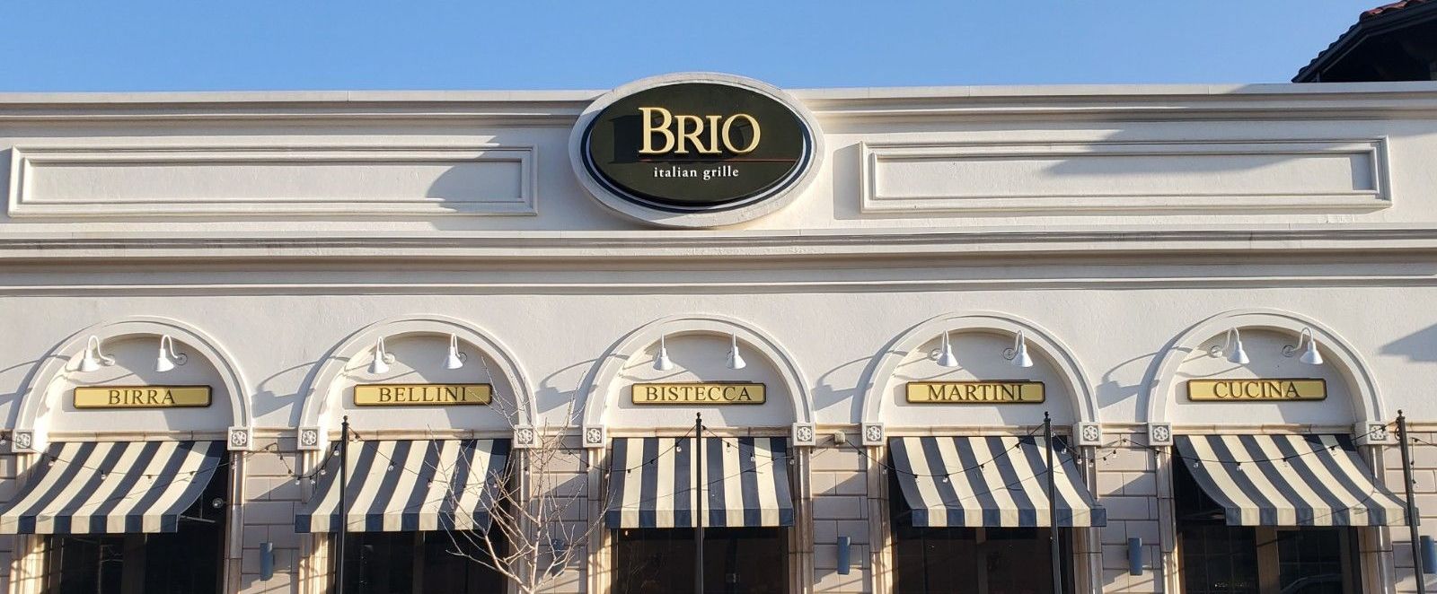 A white building with a sign that says brio on it