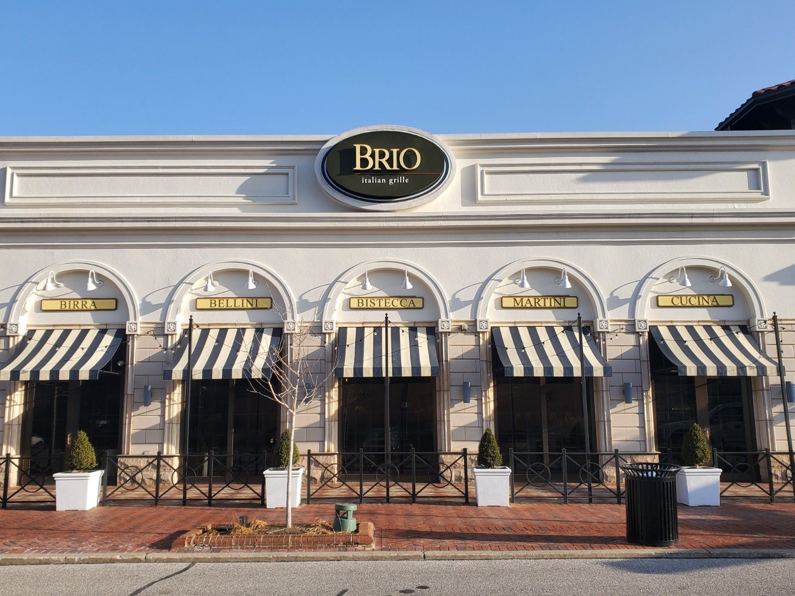 A white building with a sign that says brio on it
