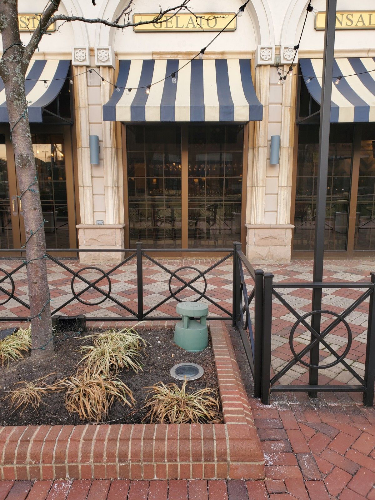 A building with a striped awning on the front of it
