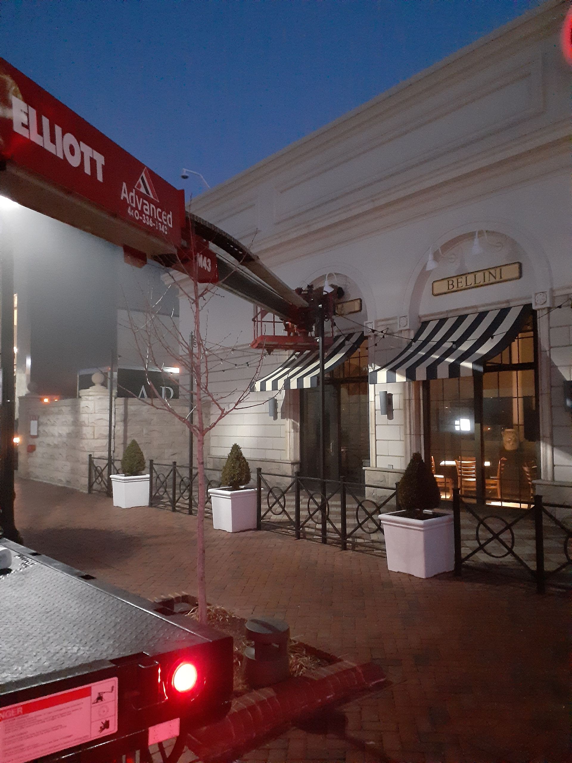 A red elliott truck is parked in front of a building