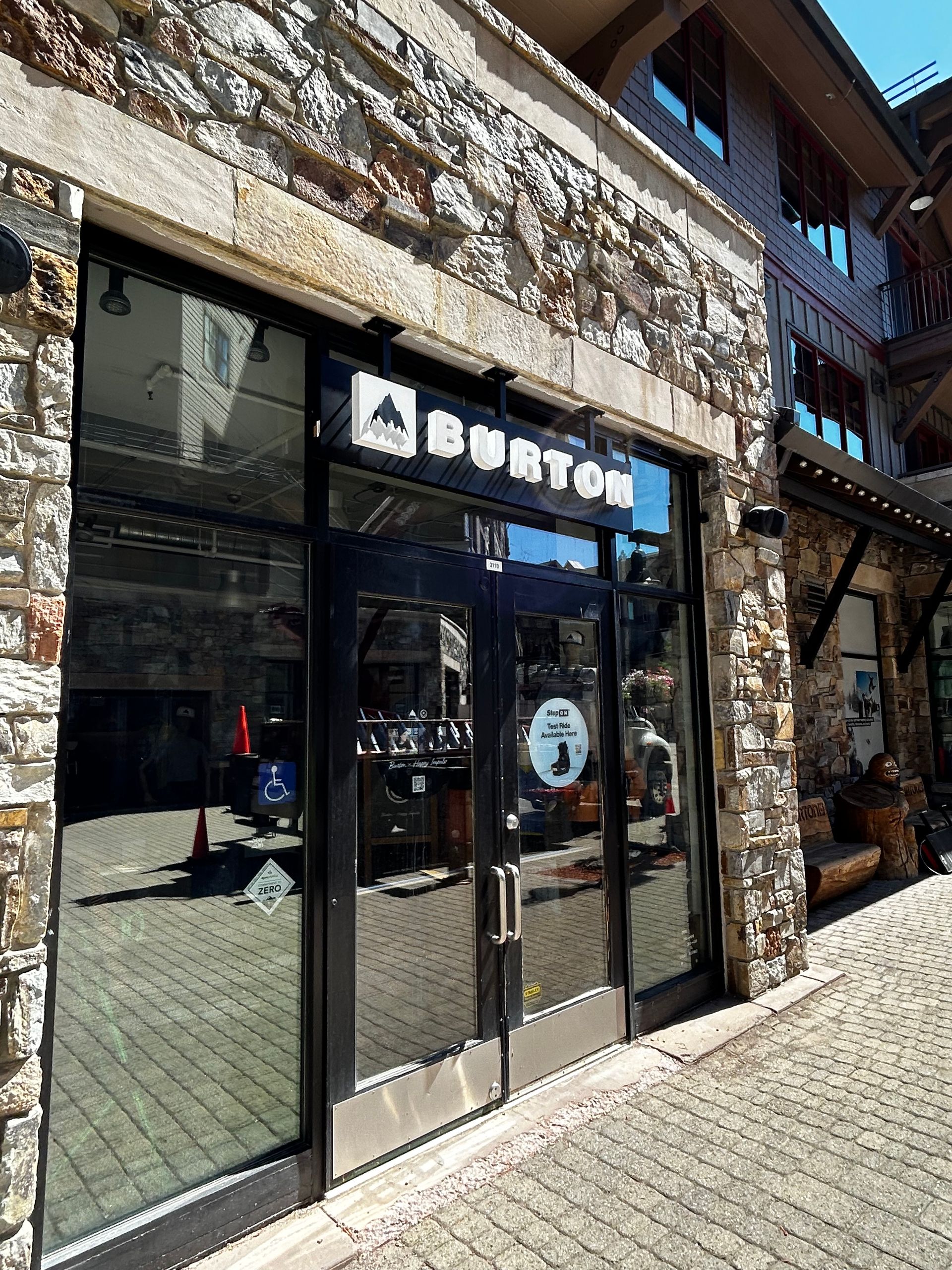 A burton sign is on the side of a brick building.