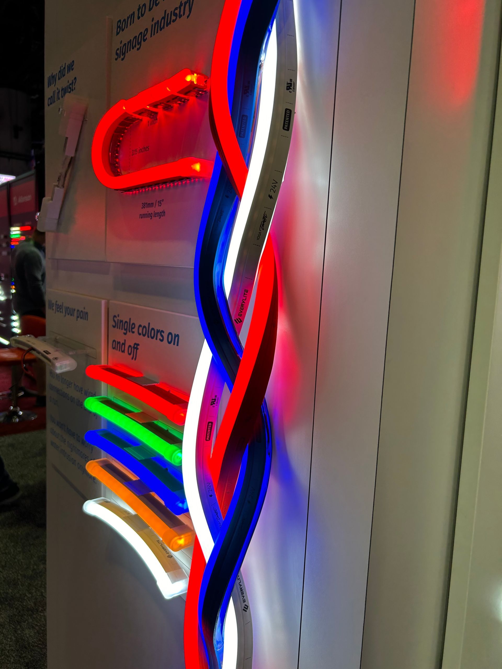A display of neon signs with one that says ' red white and blue ' on it