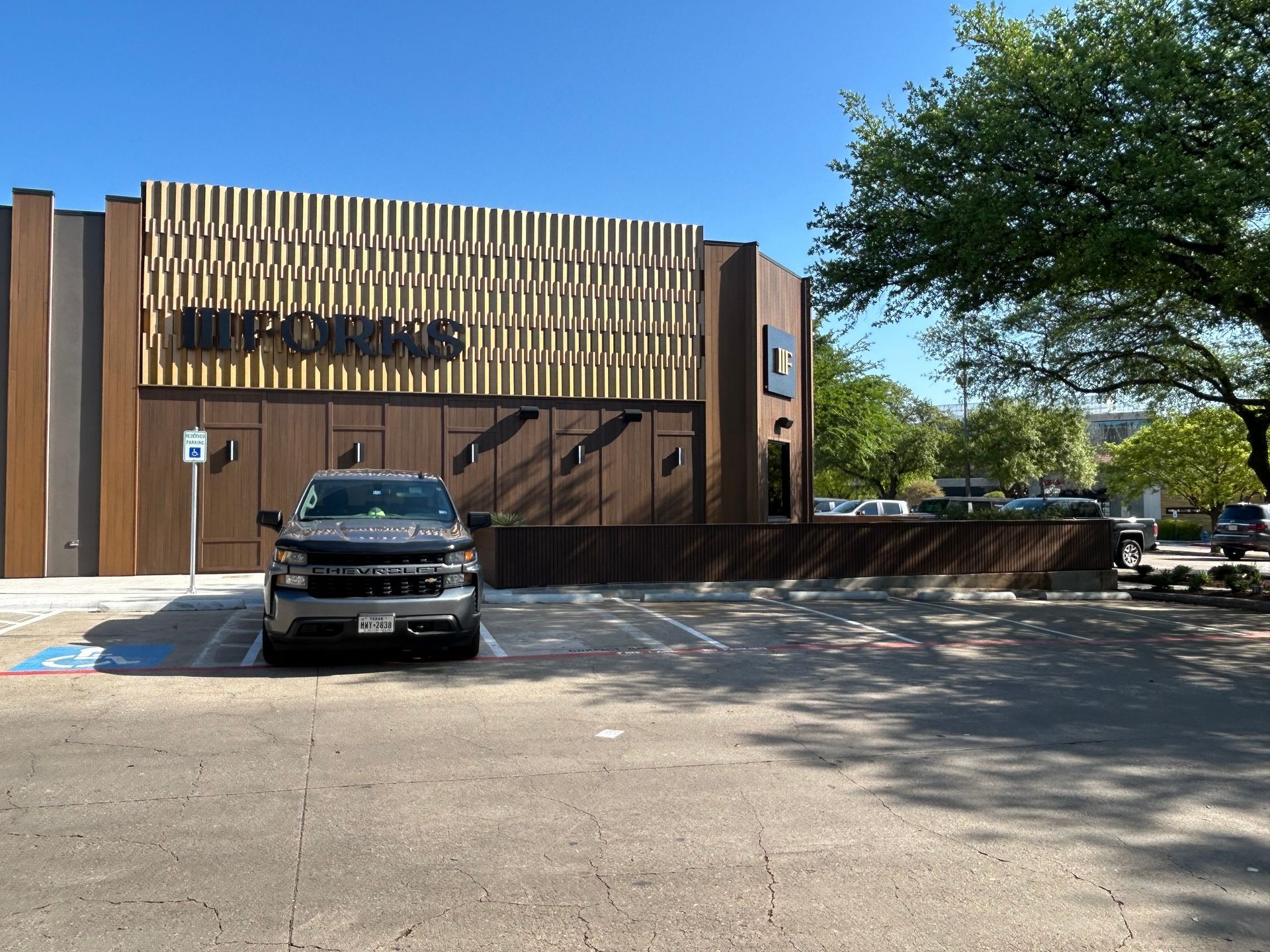 A car is parked in front of a building that says poke