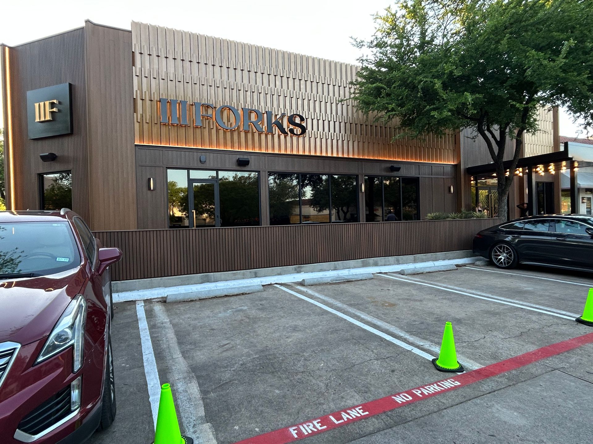 A red car is parked in front of a building.
