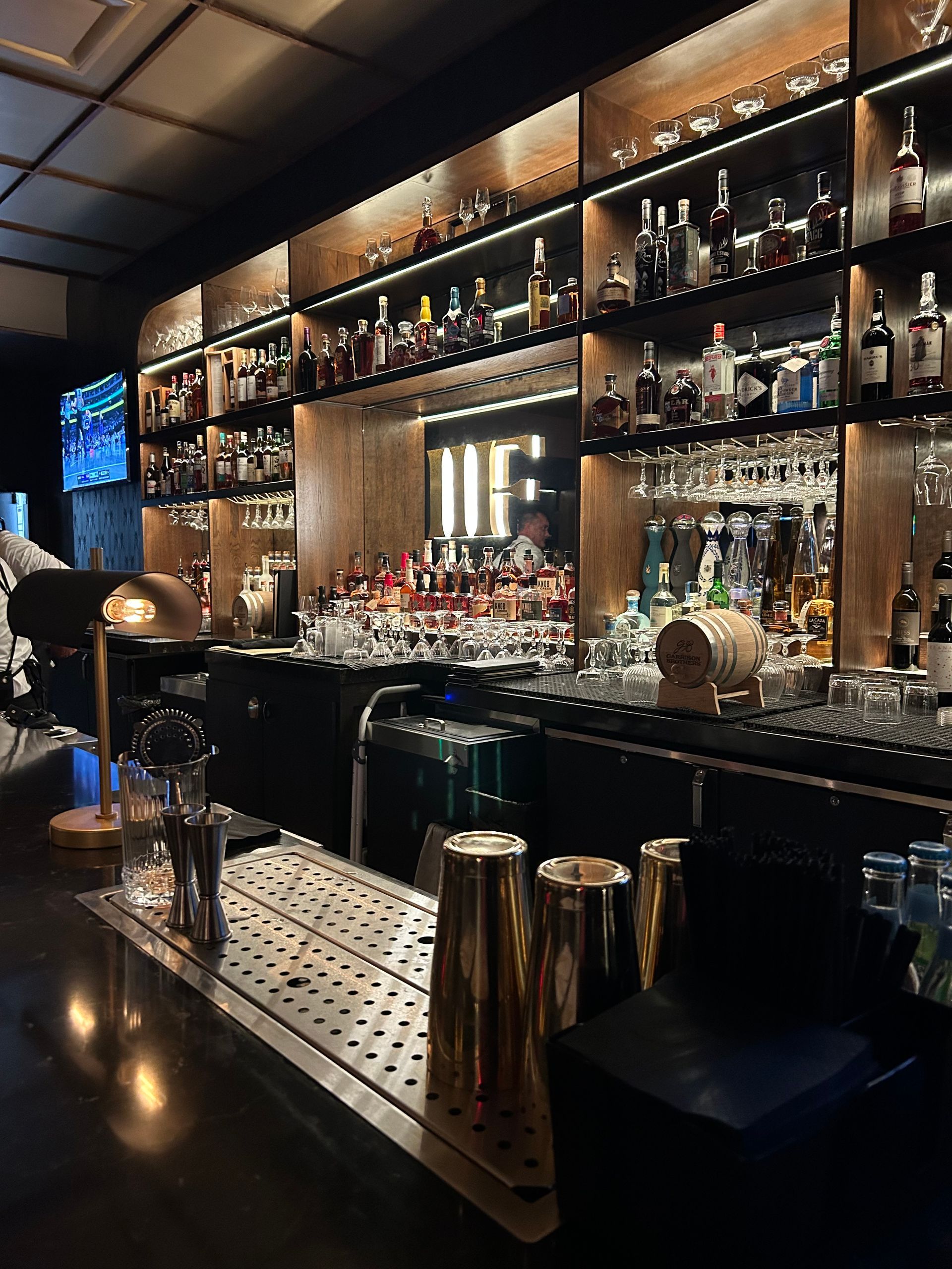 A bar filled with lots of bottles and glasses