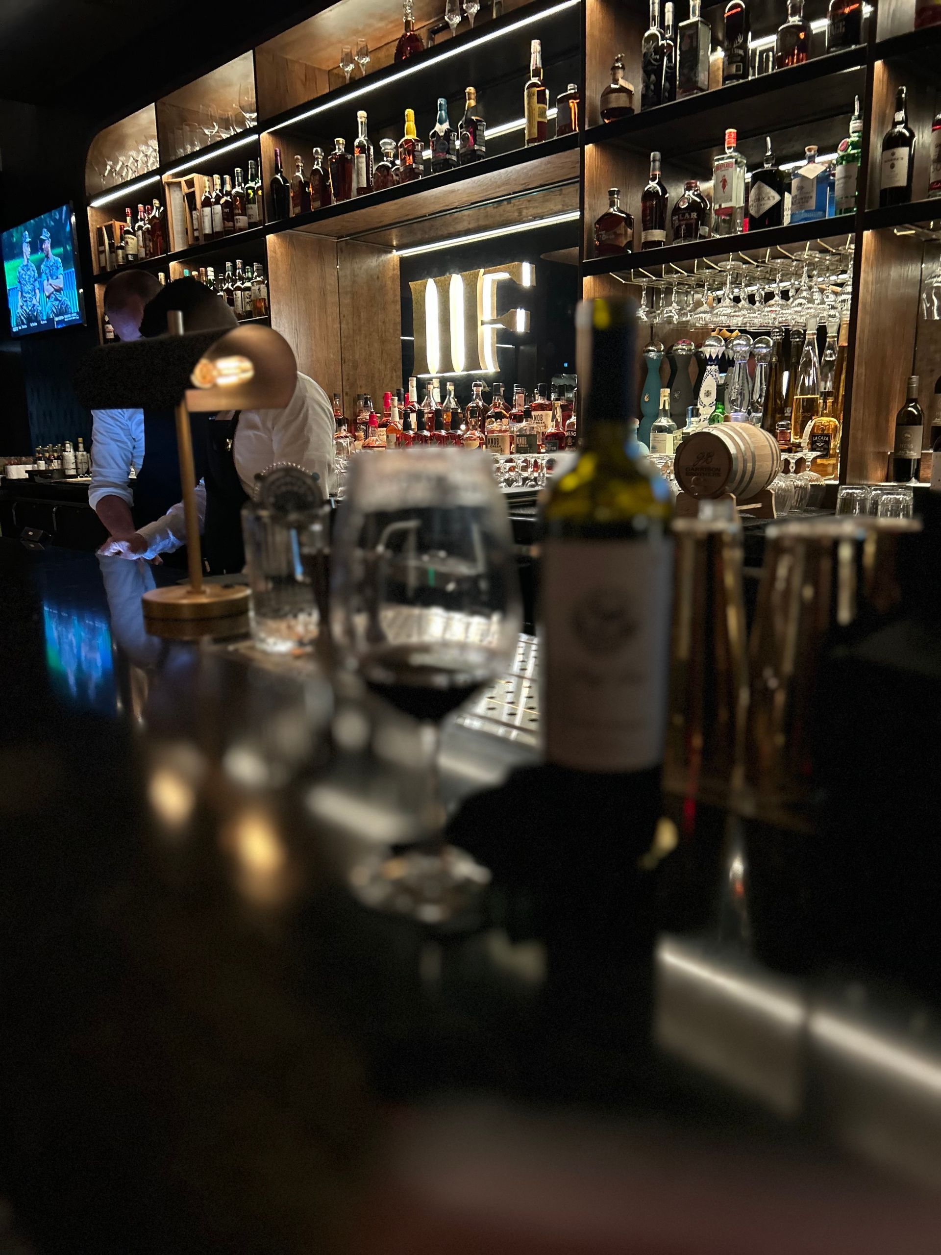 A bar with a bottle of wine on the counter