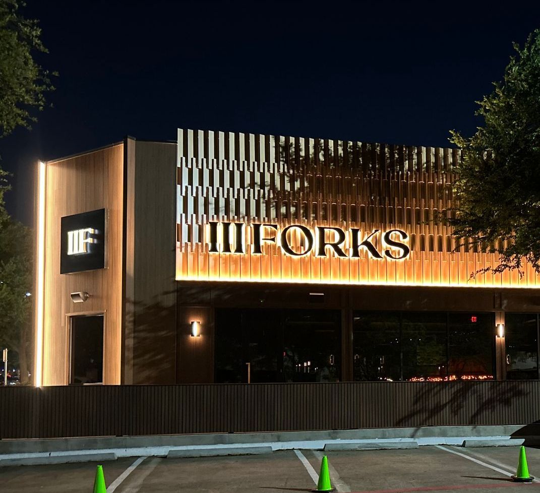The forks restaurant is lit up at night