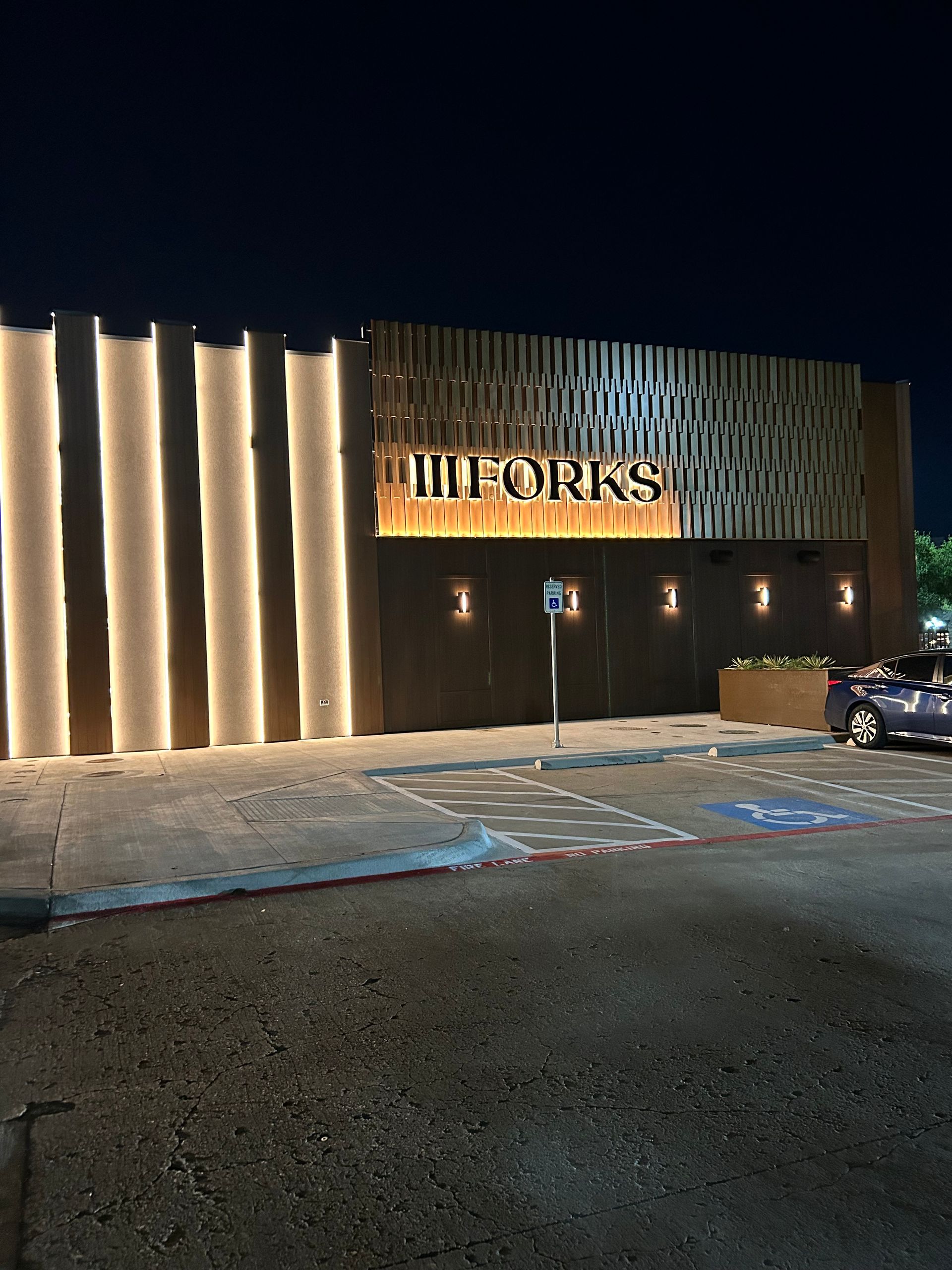 A building with the word forks on it is lit up at night