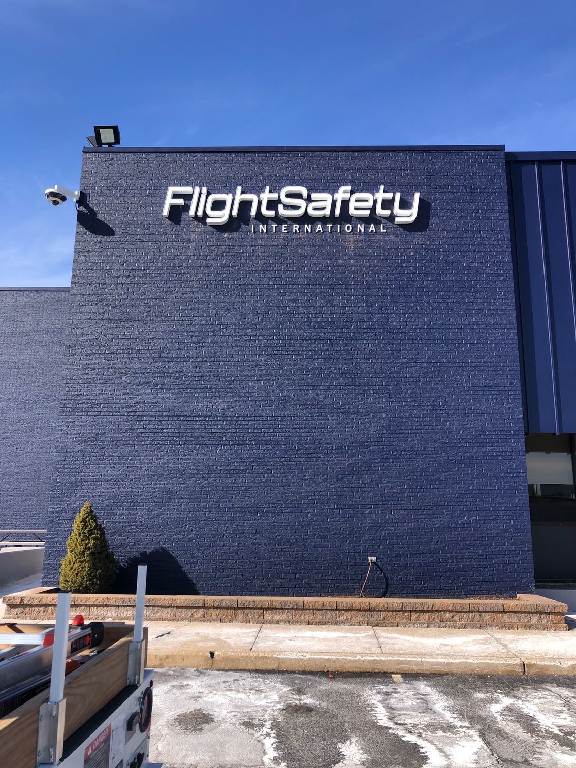 A blue building with a sign that says flight safety on it.