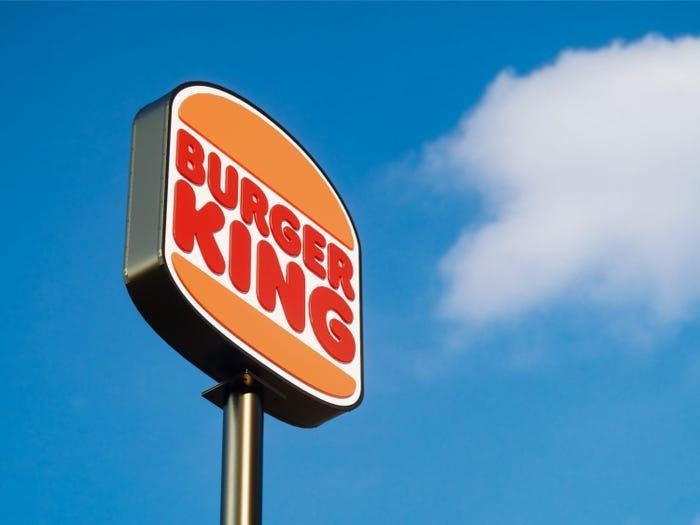 A burger king sign against a blue sky