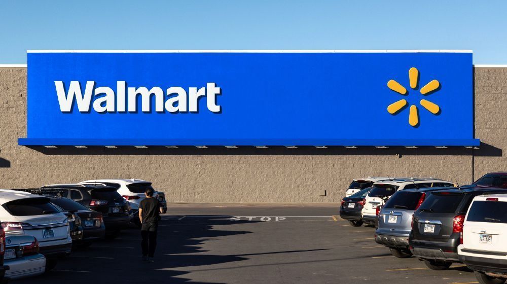 A walmart store with cars parked in front of it