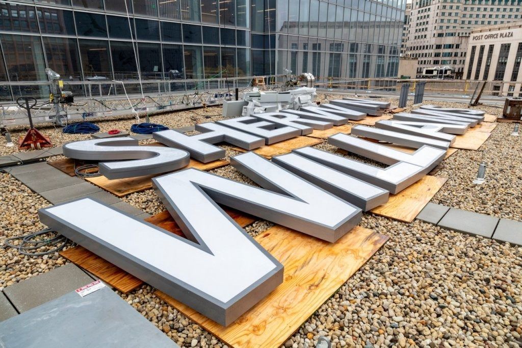 A large sign on the roof of a building that says sheraton