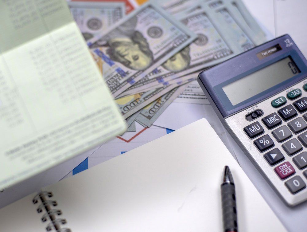 Money And Calculator — Grand Blanc, MI — Darby Tax Service Money And Calculator — Grand Blanc, MI — Darby Tax Service