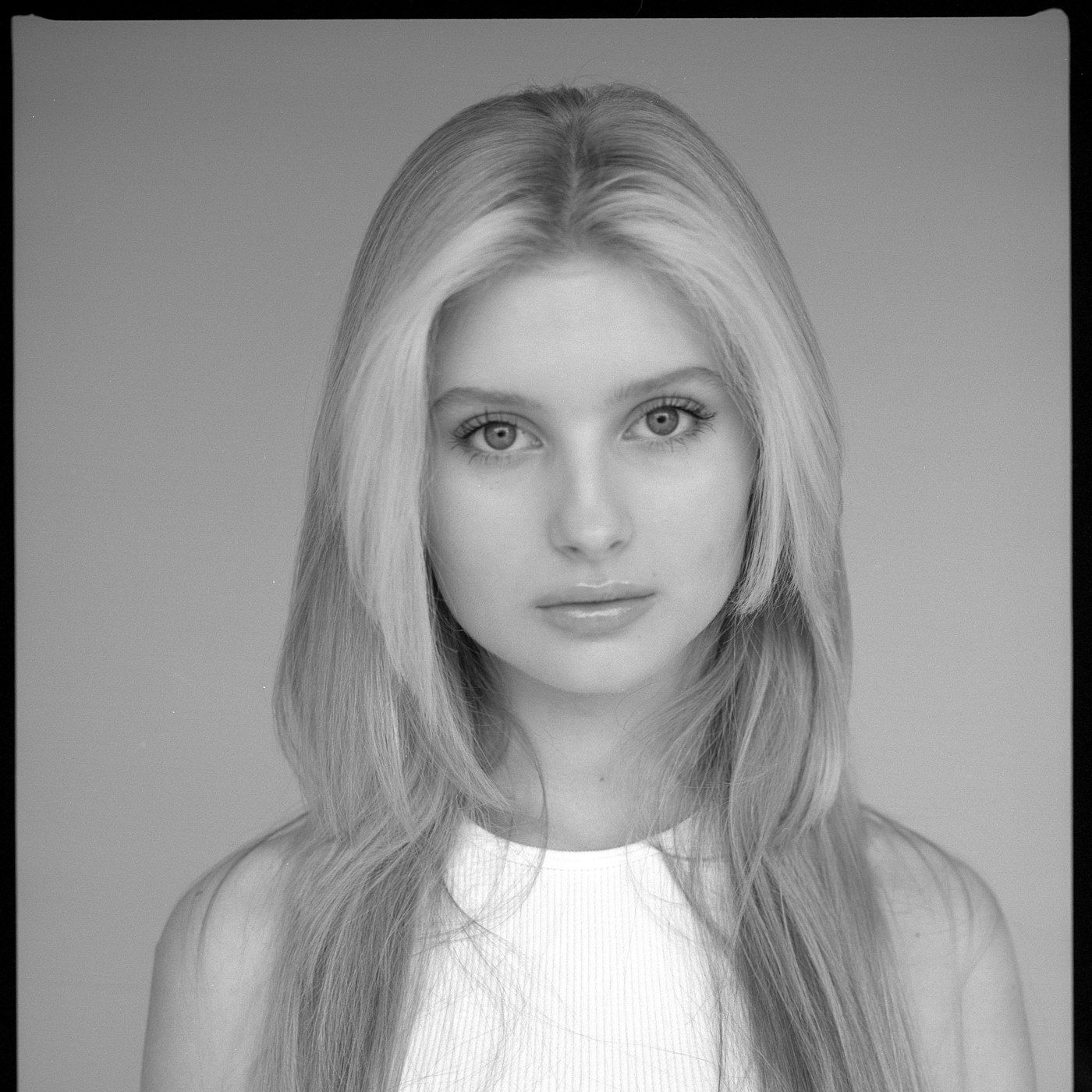 A beauty model photographed in even, controlled studio light
