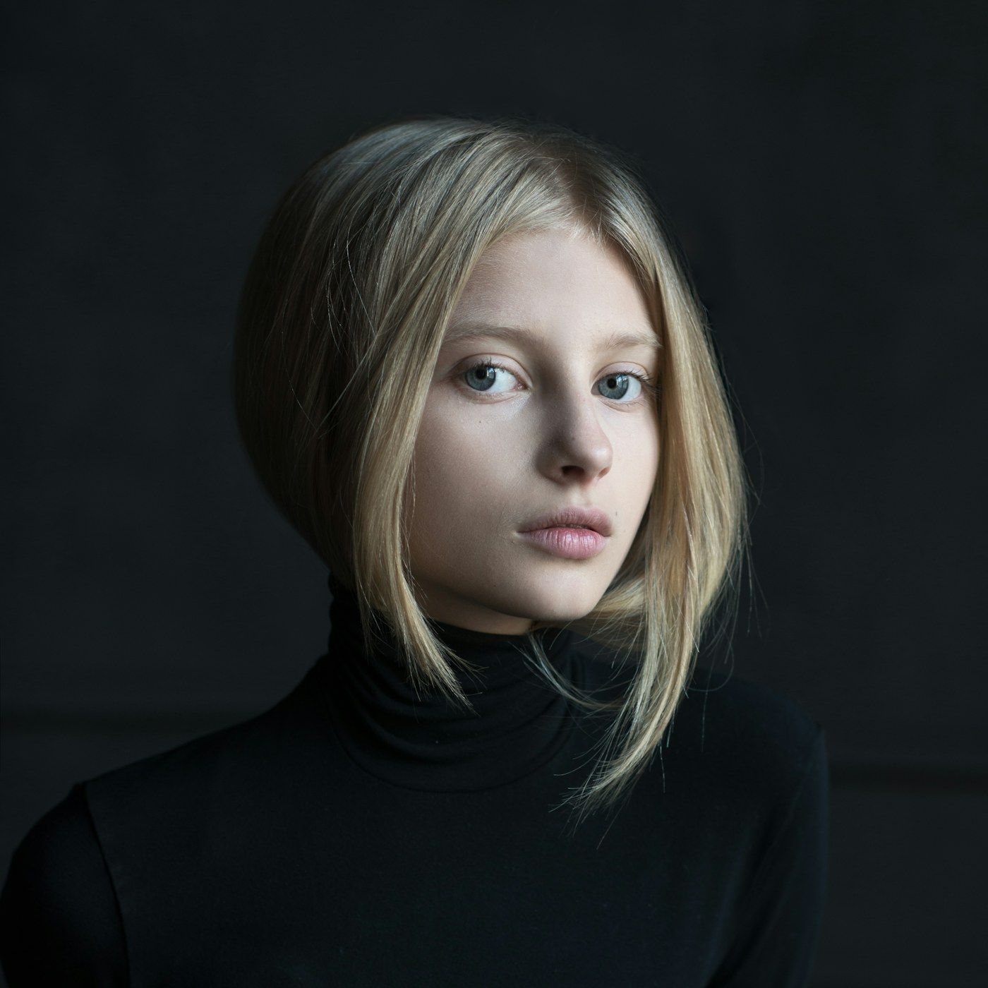 A composed studio portrait of a well presented adult