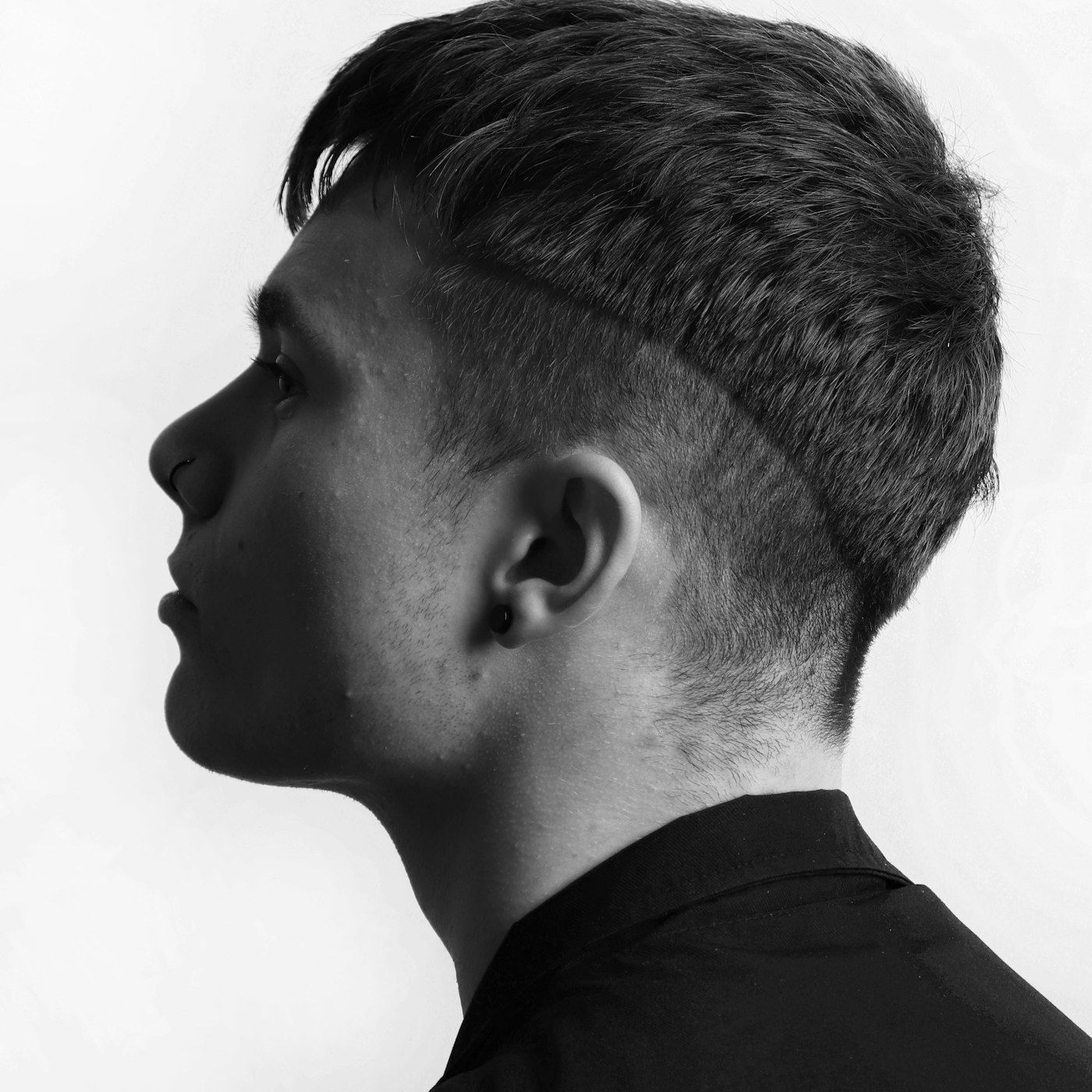 A confident, composed man in clean studio light
