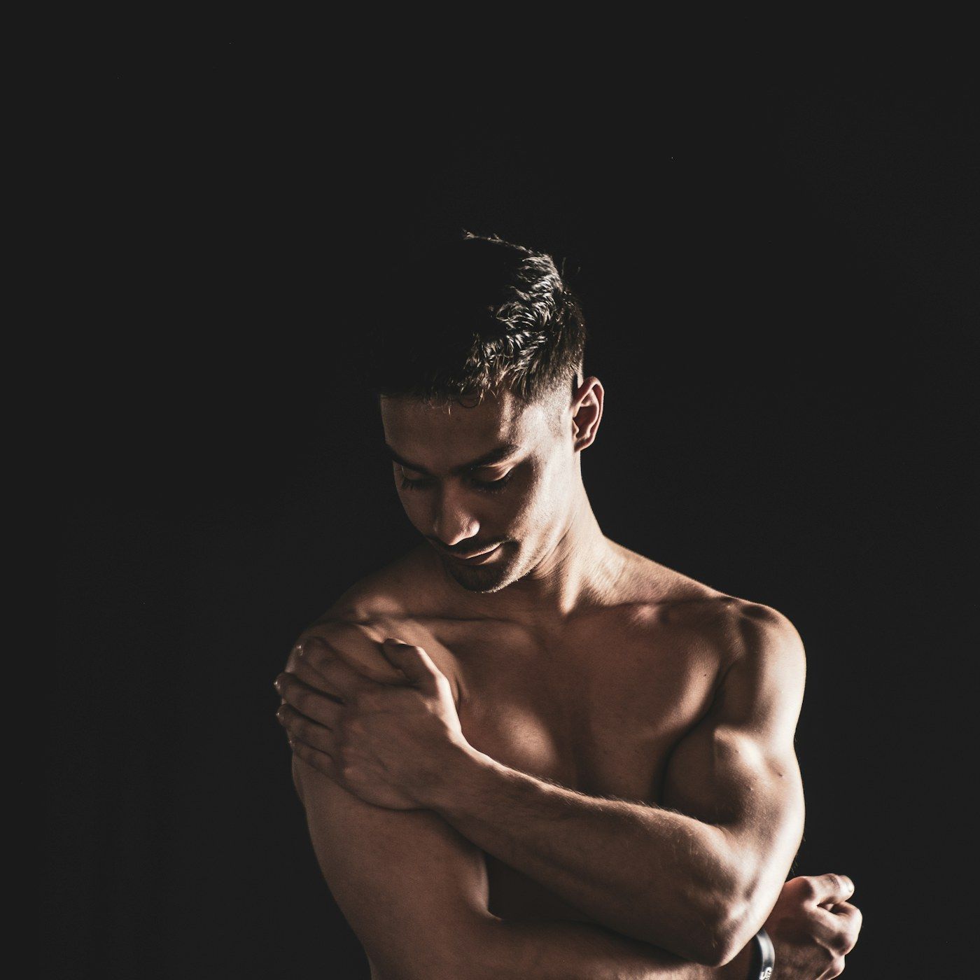 A strong, well groomed man in clean studio light