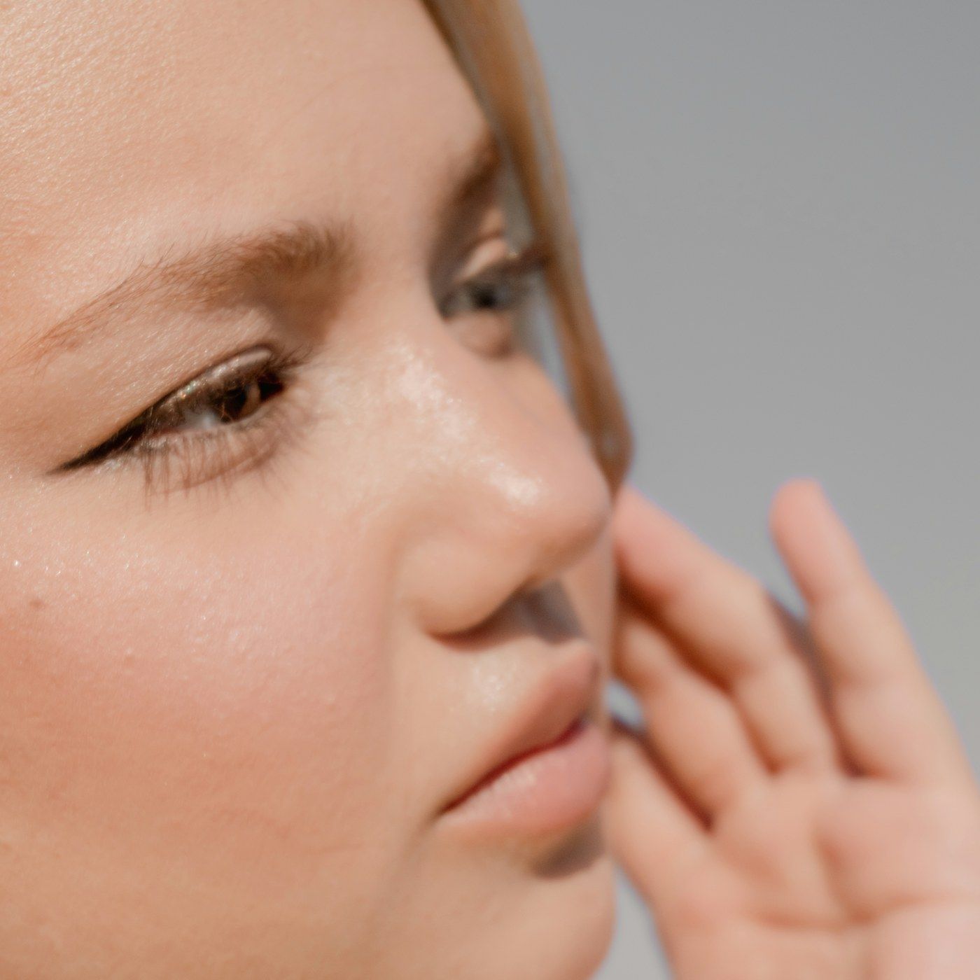 A calm studio portrait showing clear, even skin