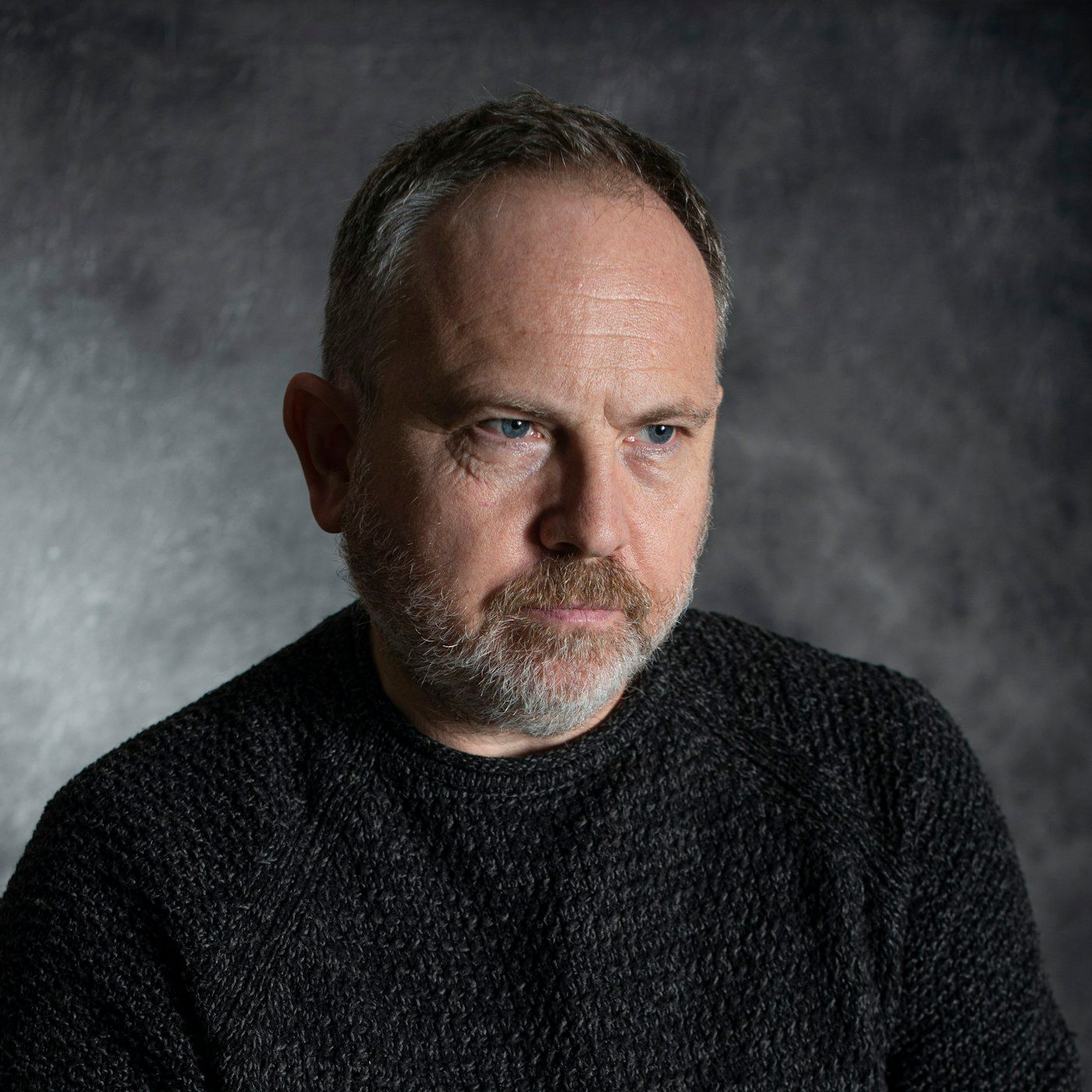 A healthy, composed adult in a warm studio portrait