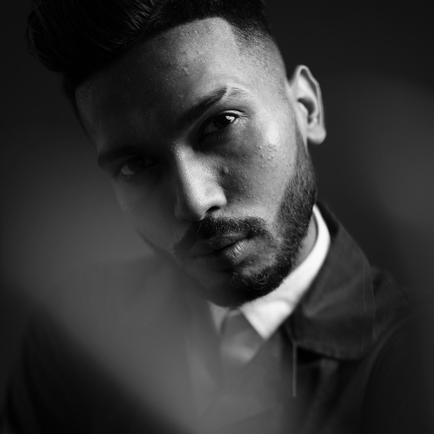A confident, well presented man in clean studio light