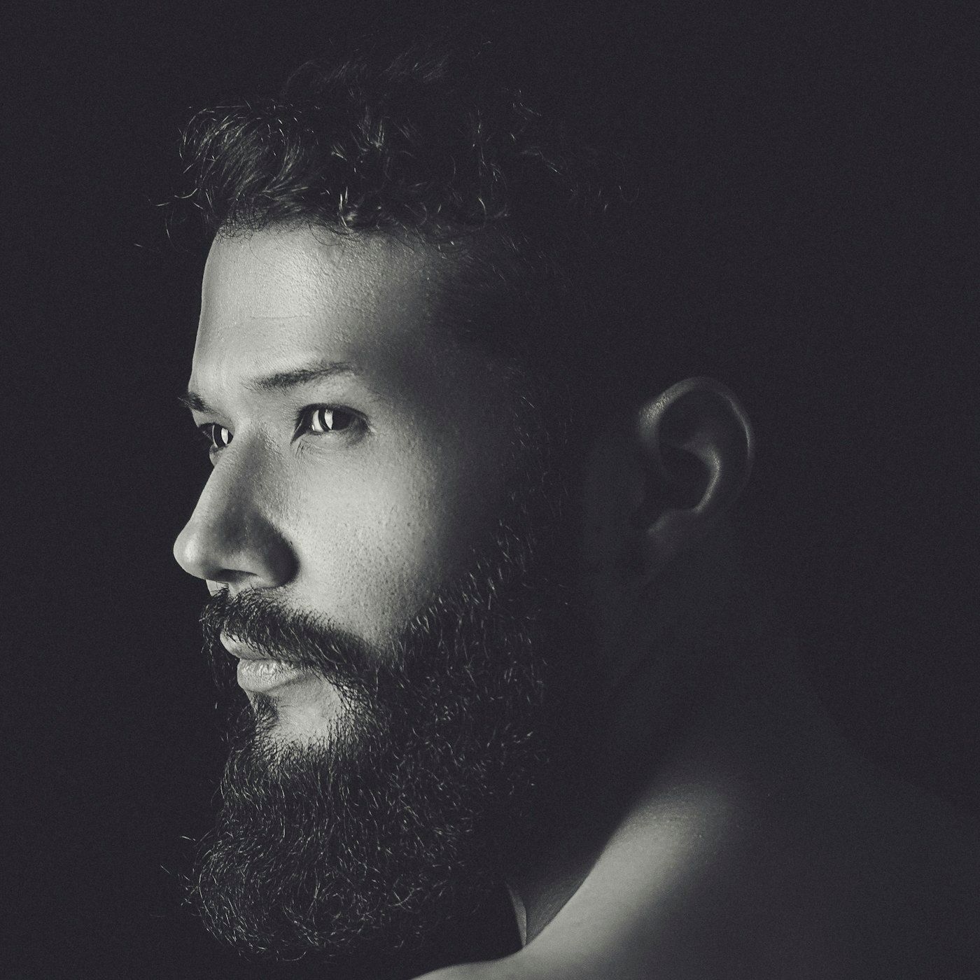 A confident, well groomed man in clean studio light