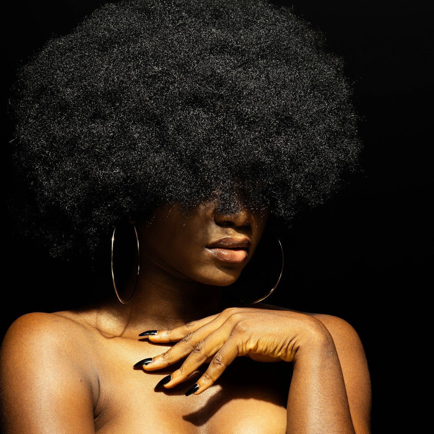 A composed studio portrait with unmarked skin