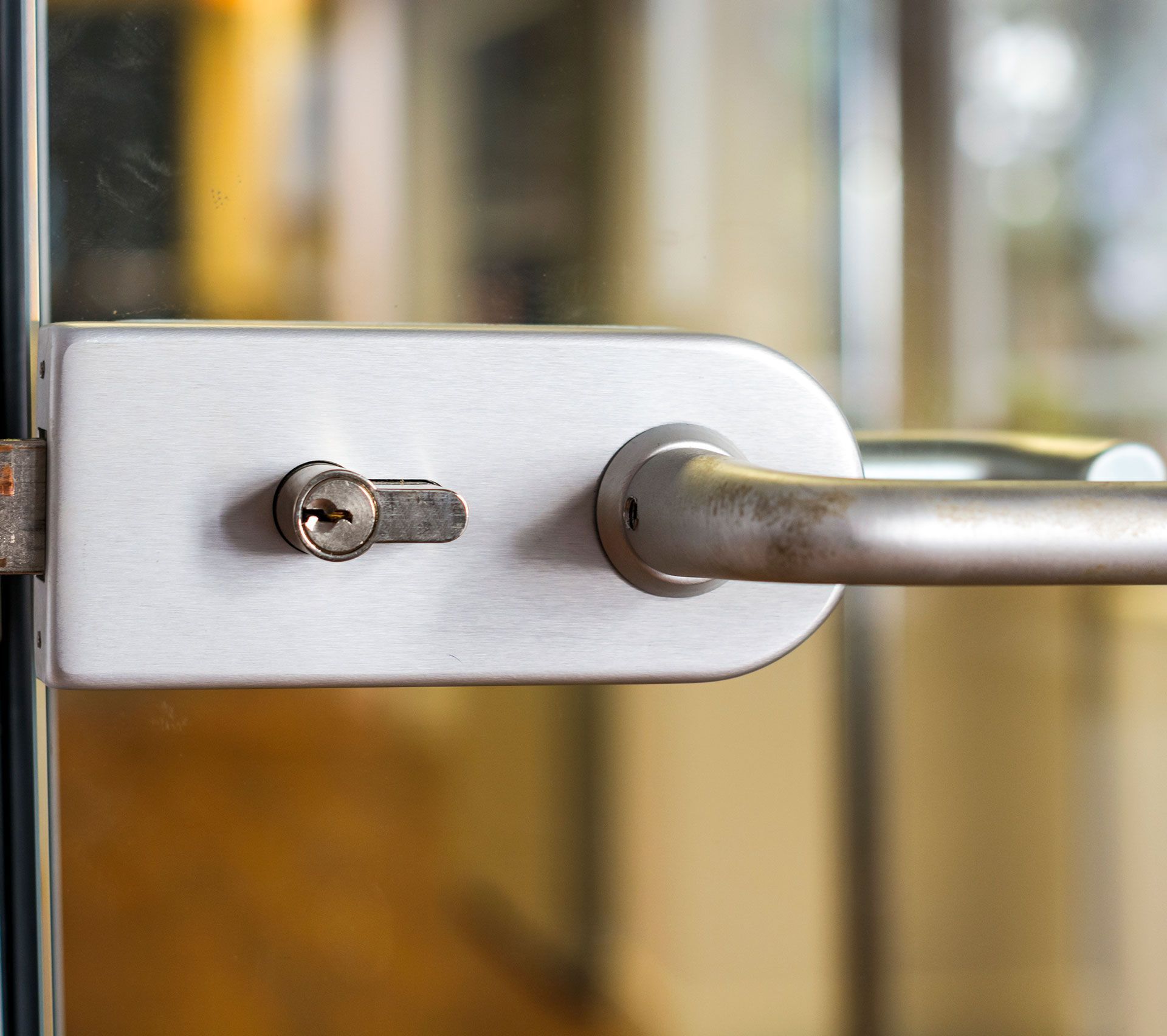 A close up of a door handle with a key on it.