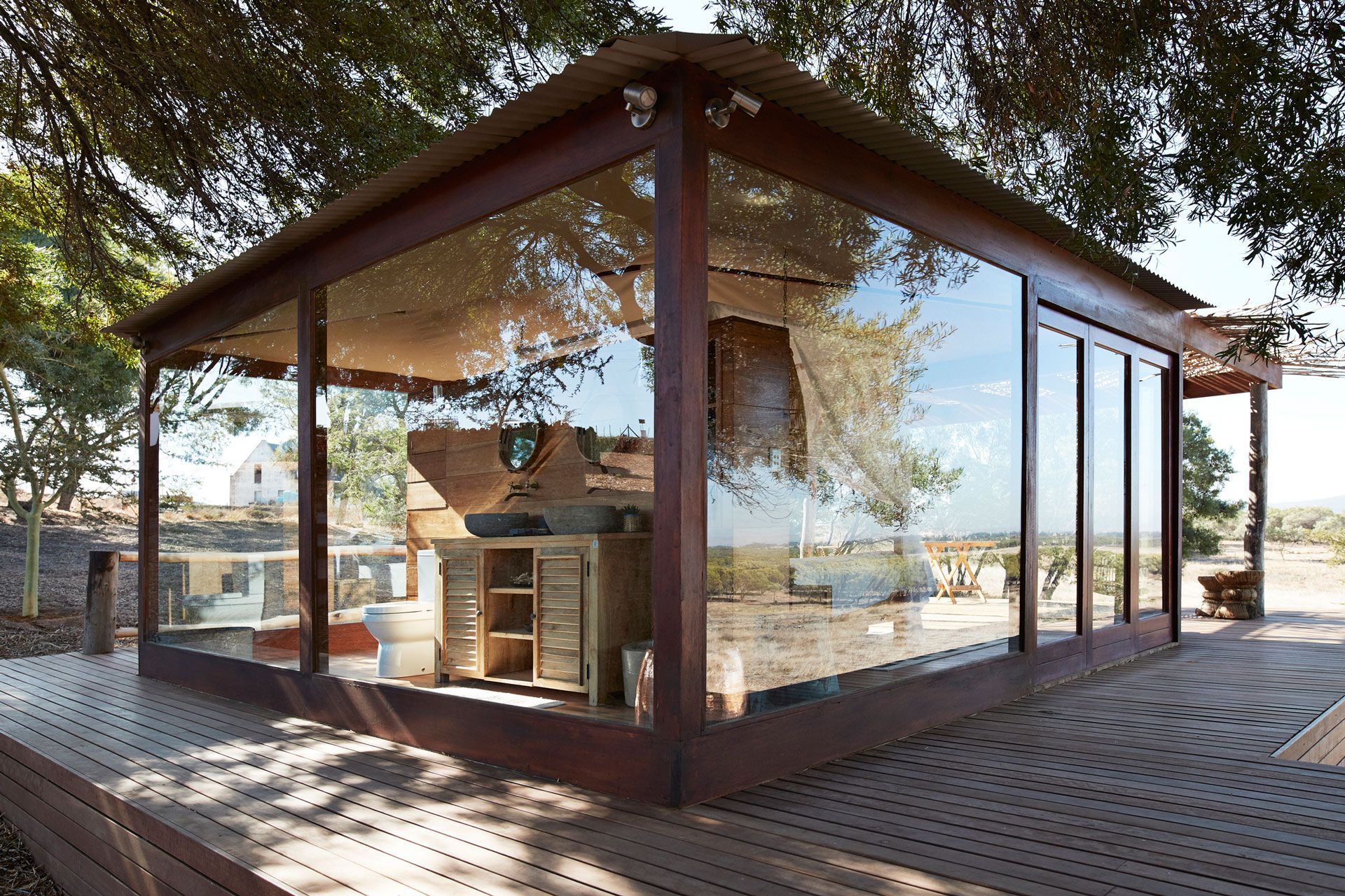 A house with a lot of windows and a wooden deck