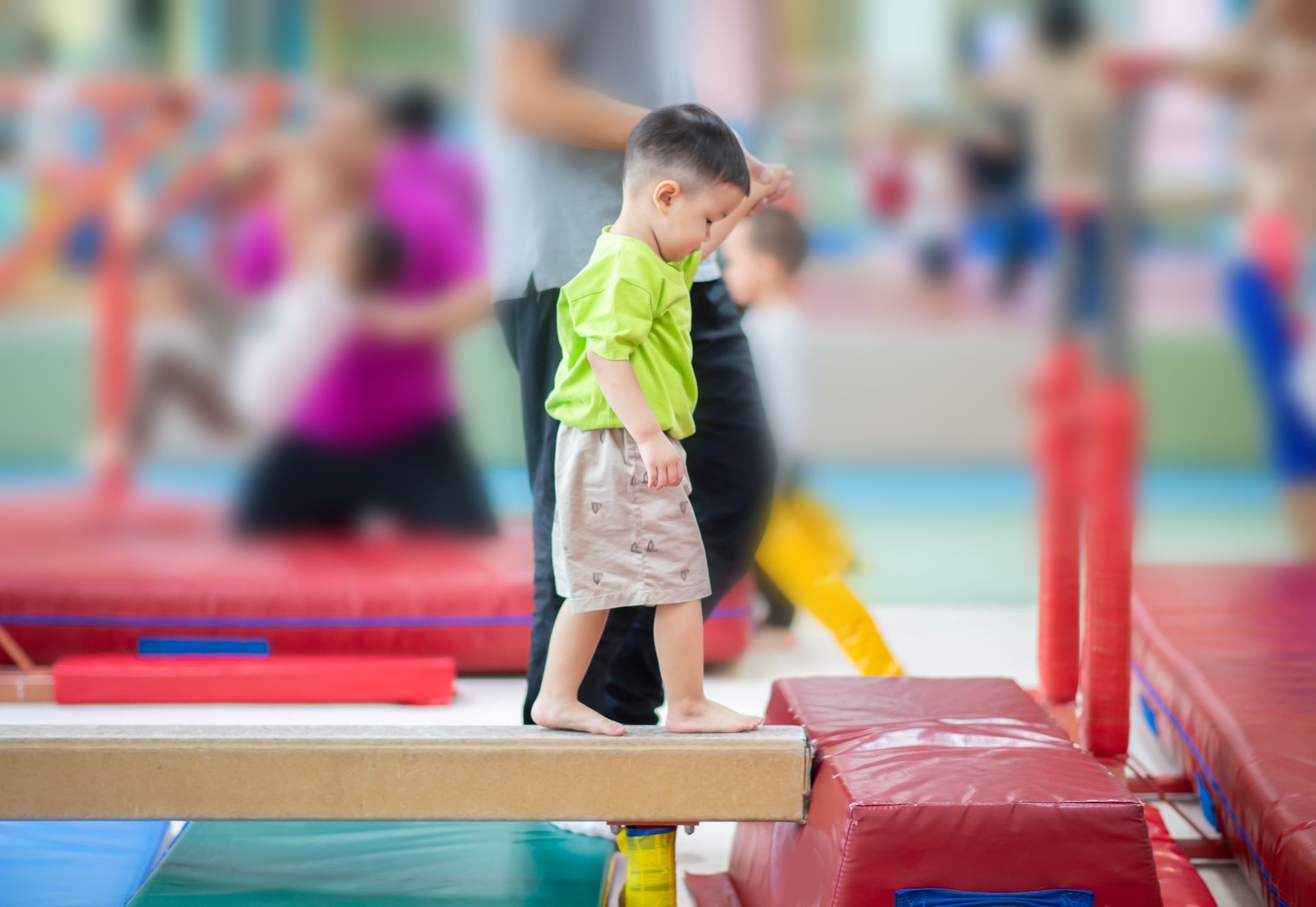 Preschool boy walking on balance beam