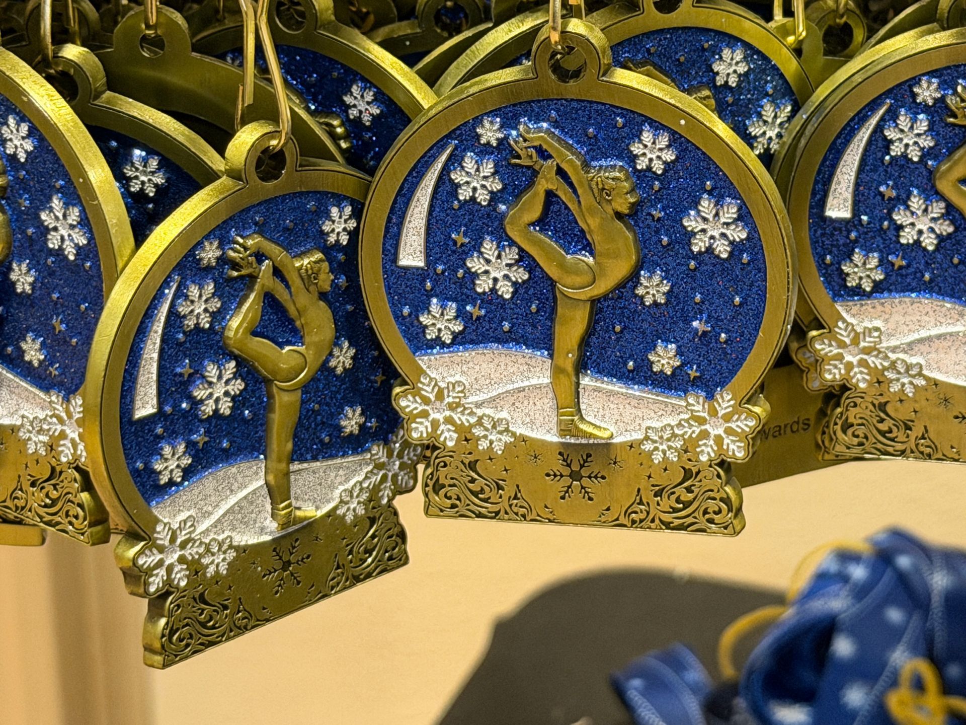 Blue-and-gold decorative medals or ornaments with tassels on display