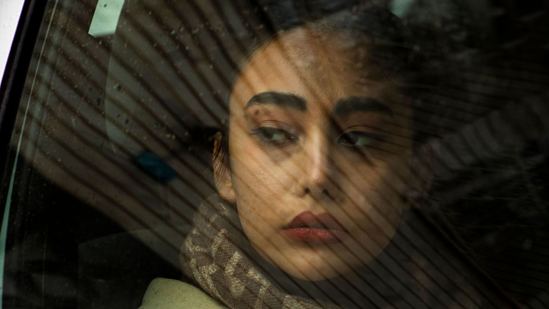 A dementia caregiver taking a quiet moment in her car to cope with the guilt of leaving a parent in 