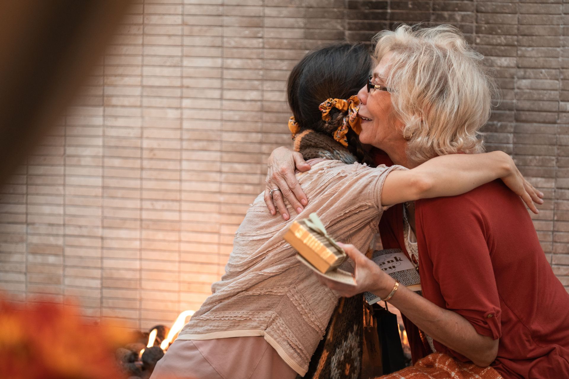 A daughter sharing a warm hug and a gentle goodbye with her elderly mother living with dementia.