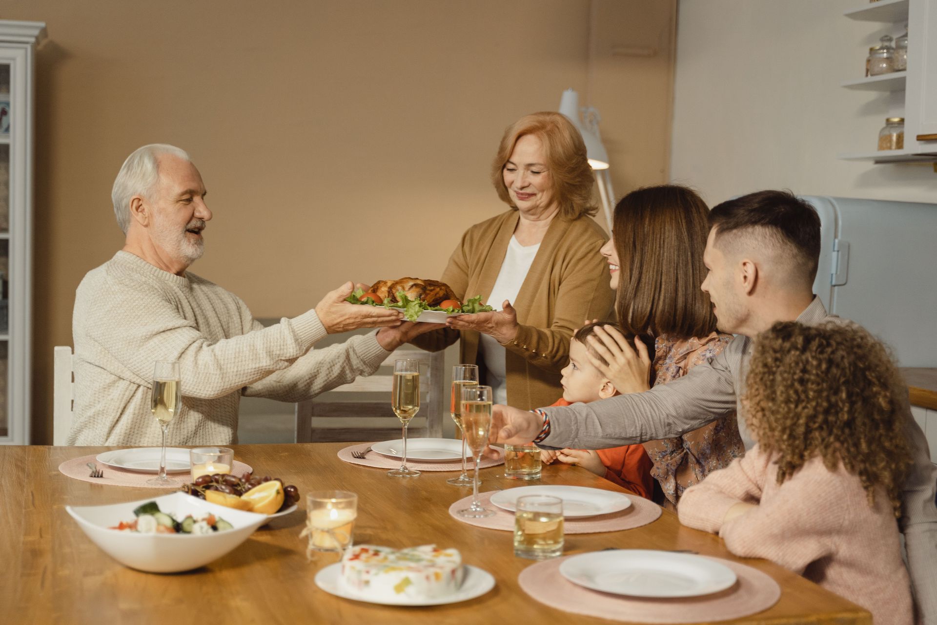 A family sharing a quiet, warm moment around a holiday table, focusing on gentle connection with an