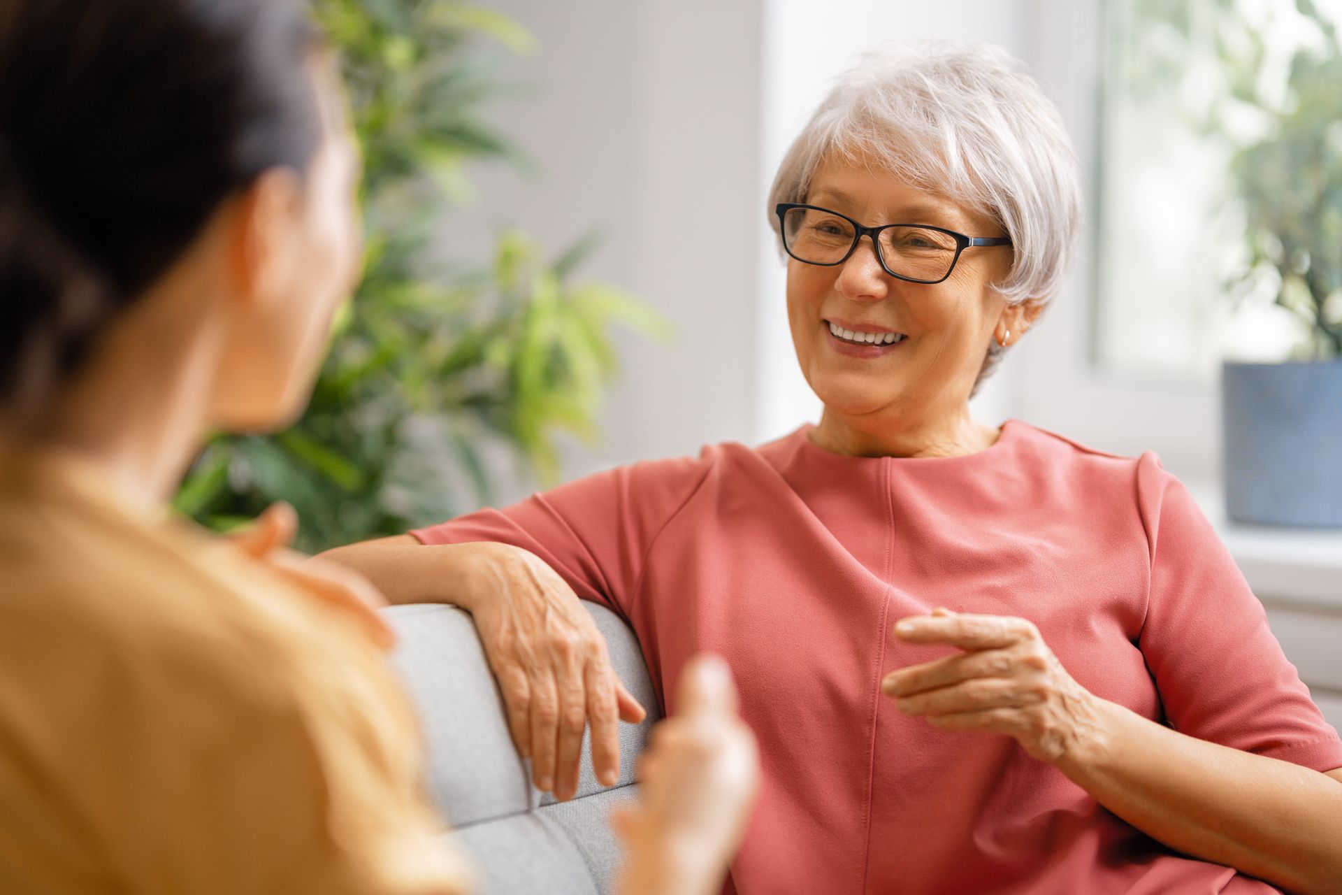 A woman sitting with a compassionate therapist, representing care for dementia caregivers