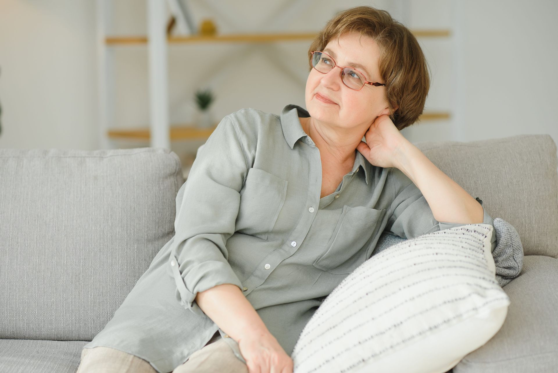 A woman sits looking relieved during a therapy session for dementia caregivers in Redmond WA
