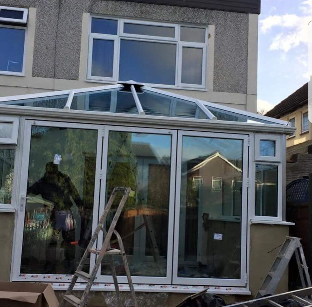 A house with a glass roof and a ladder in front of it
