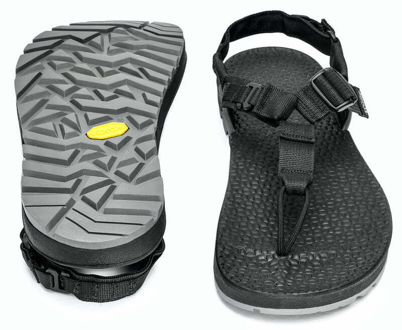 Black hiking sandal, showing sole with textured tread and straps with adjustable buckles.