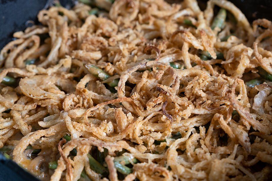Green bean casserole topped with crispy fried onions.