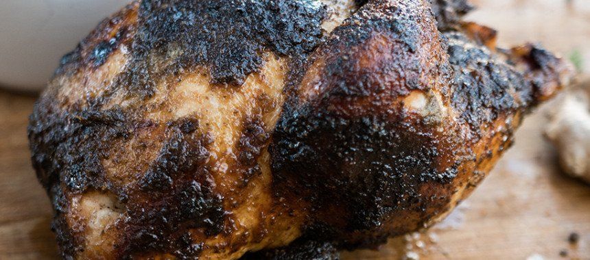 Roasted chicken with dark, charred skin.