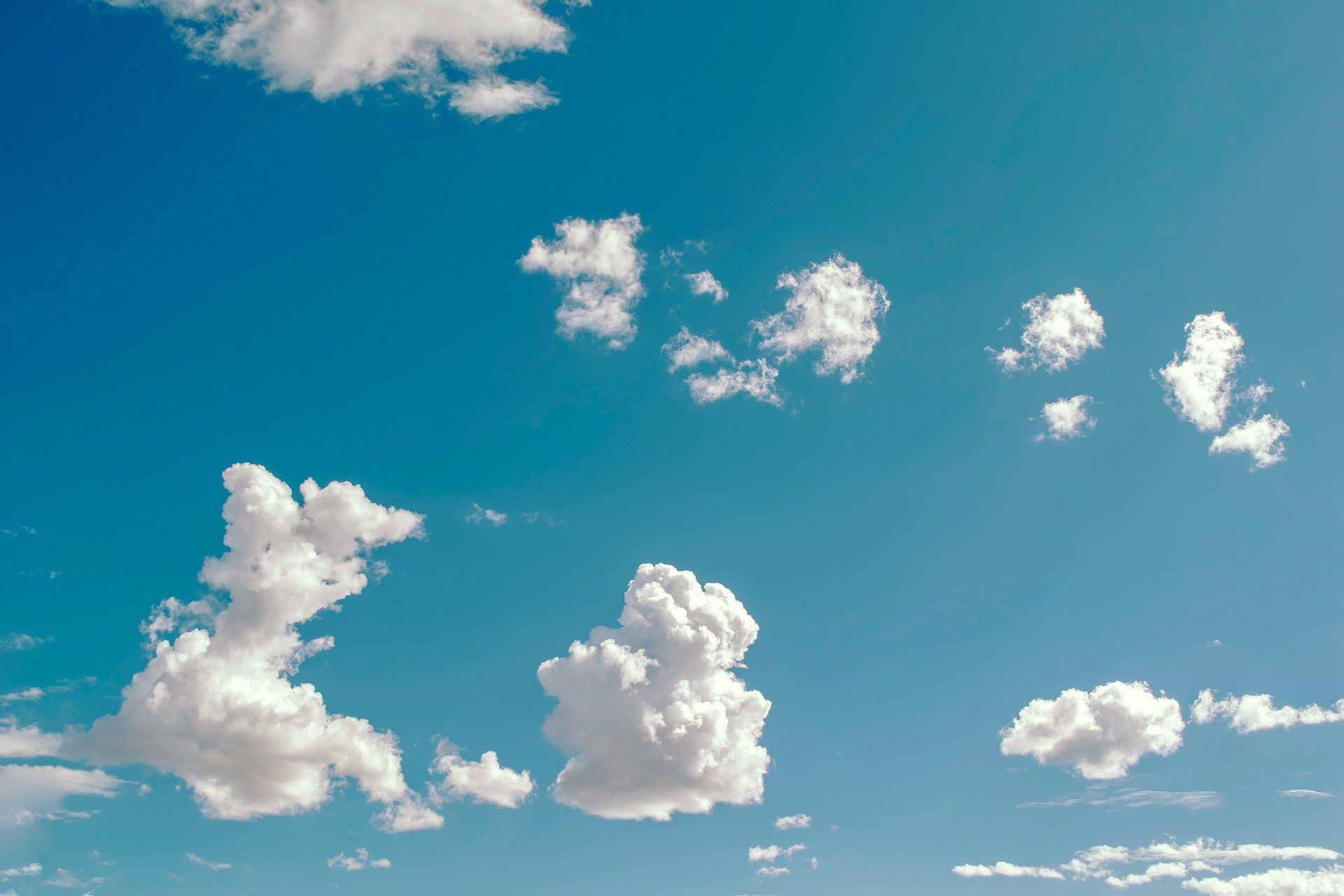 Blue sky with fluffy white clouds.