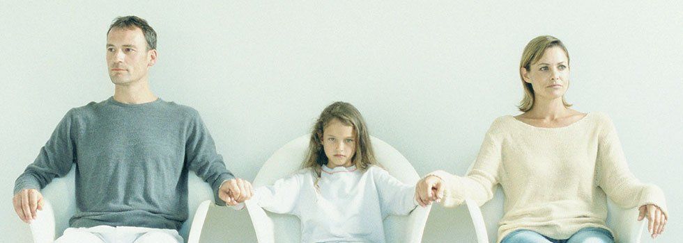 Couple holding hands with girl in the middle