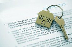 House key on top of a piece of paper