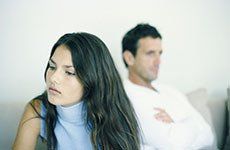 Woman sat facing away from man