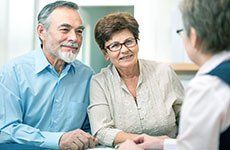 Old couple talking to solicitor