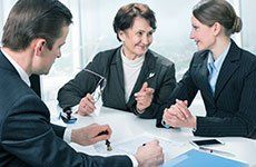 Two women and a man in a meeting
